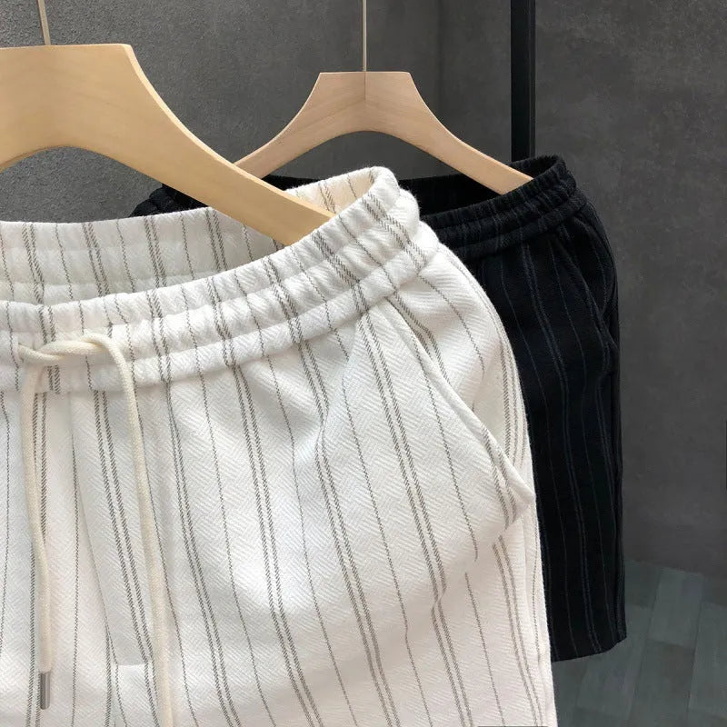 Men's black and white striped fleece-lined casual shorts showing double-layer waistband and straight-leg cut