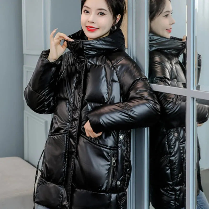 Women's loose fit hooded winter jacket in green colour showing long sleeves and thick insulation