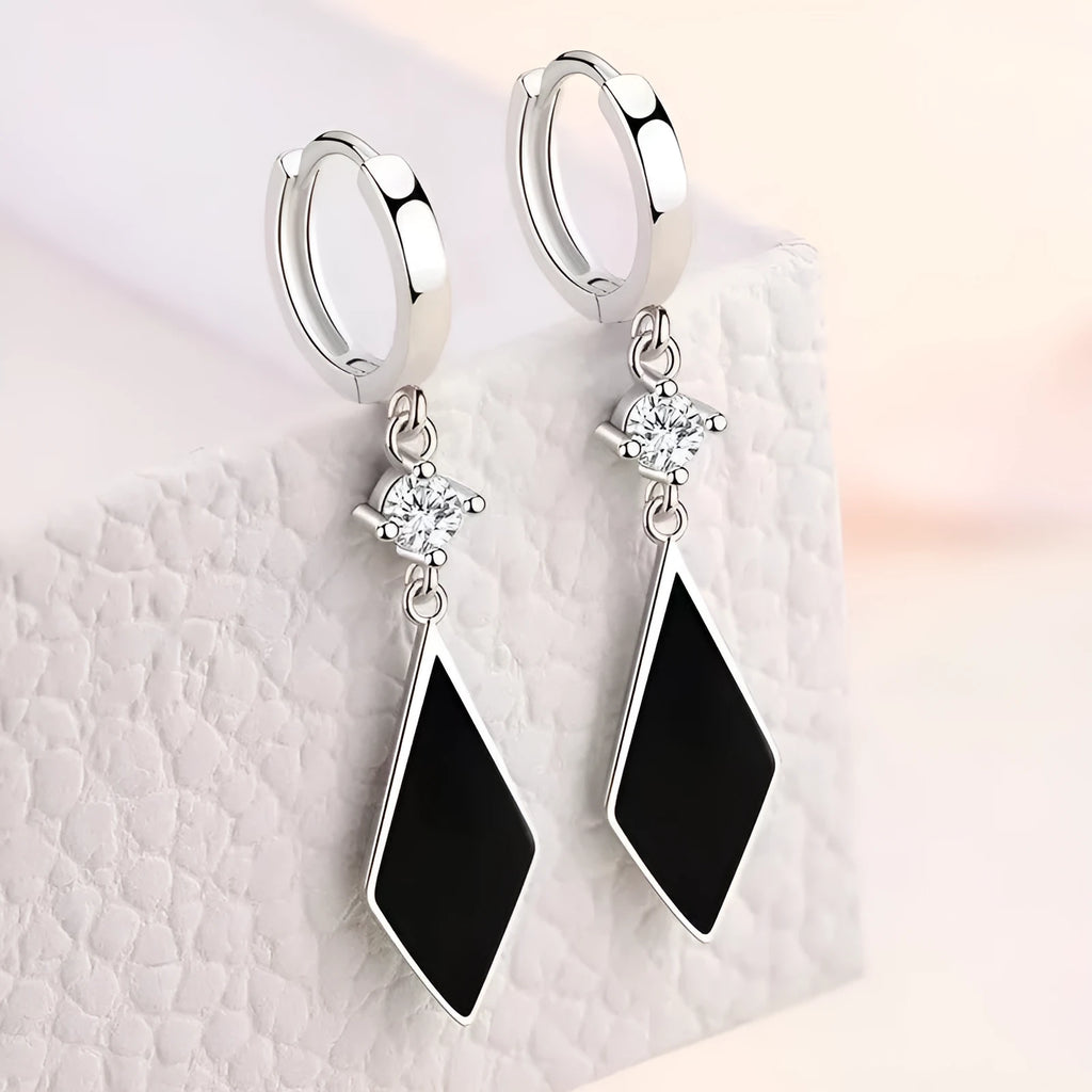 A pair of silver-coloured vintage geometric diamond earrings with an ear clip fastening.