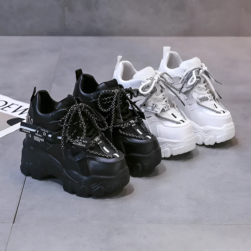Women's white and black mesh platform sports shoes with cross-strap and rubber sole.