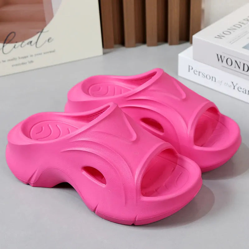 Women's white EVA slippers with thick sole and round toe on a beach background