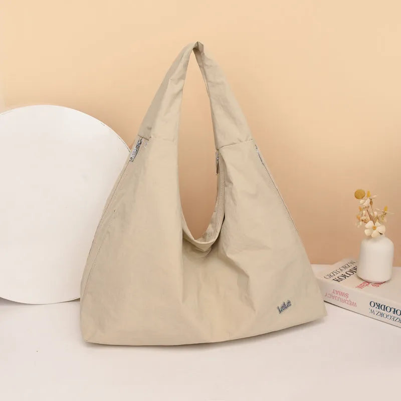 Soft nylon women's underarm bag in a heart shape, shown in black, blue, khaki, and yellow colour options.