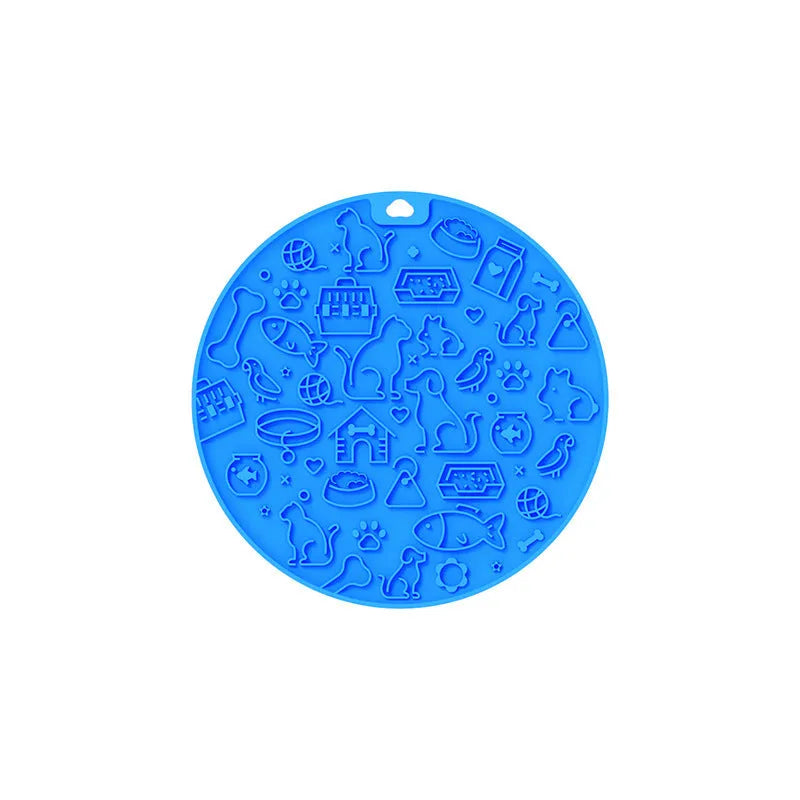 Round silicone pet licking mat with suction cup base in blue colour on a floor.