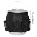 Black cylindrical polyester storage bag hanging on a 5-gallon barrel for outdoor tool organisation