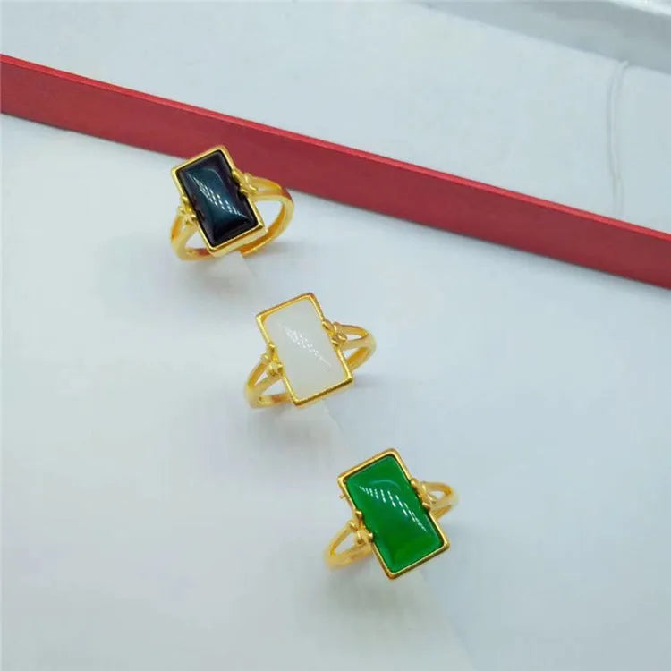 Adjustable brass ring with gold plating and coloured gemstone in national style design