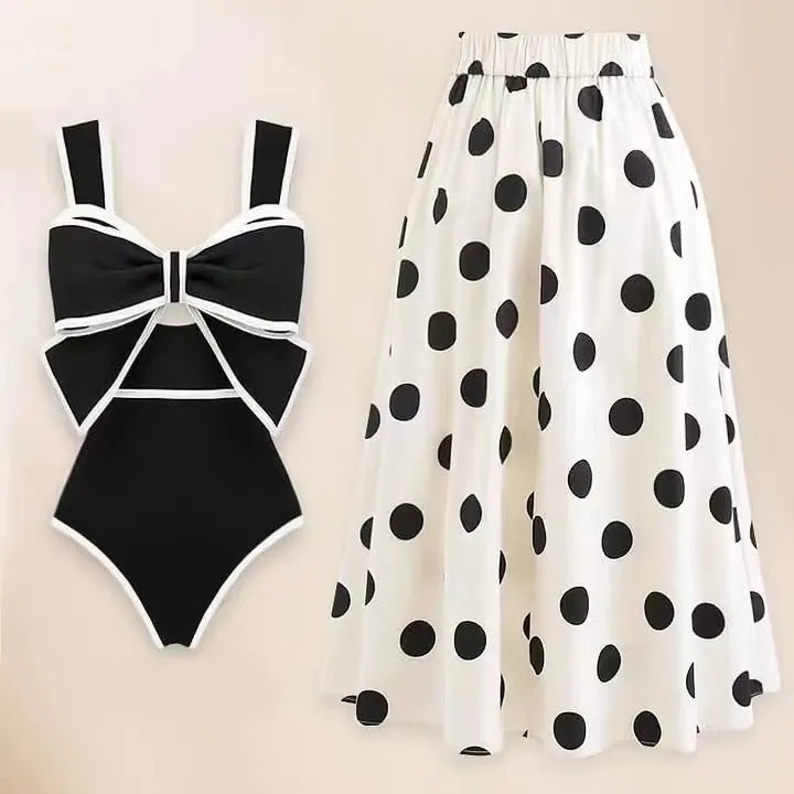Women's black one-piece swimsuit with white round skirt and bow detail for beach and swimming
