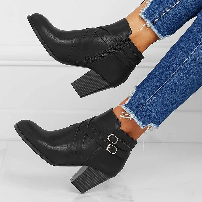 Women's black short boots with a 7cm stout heel and side zip fastener on a rubber sole.