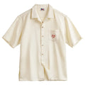 Light apricot men's Cuban collar shirt with bamboo pattern showing plants and flowers design