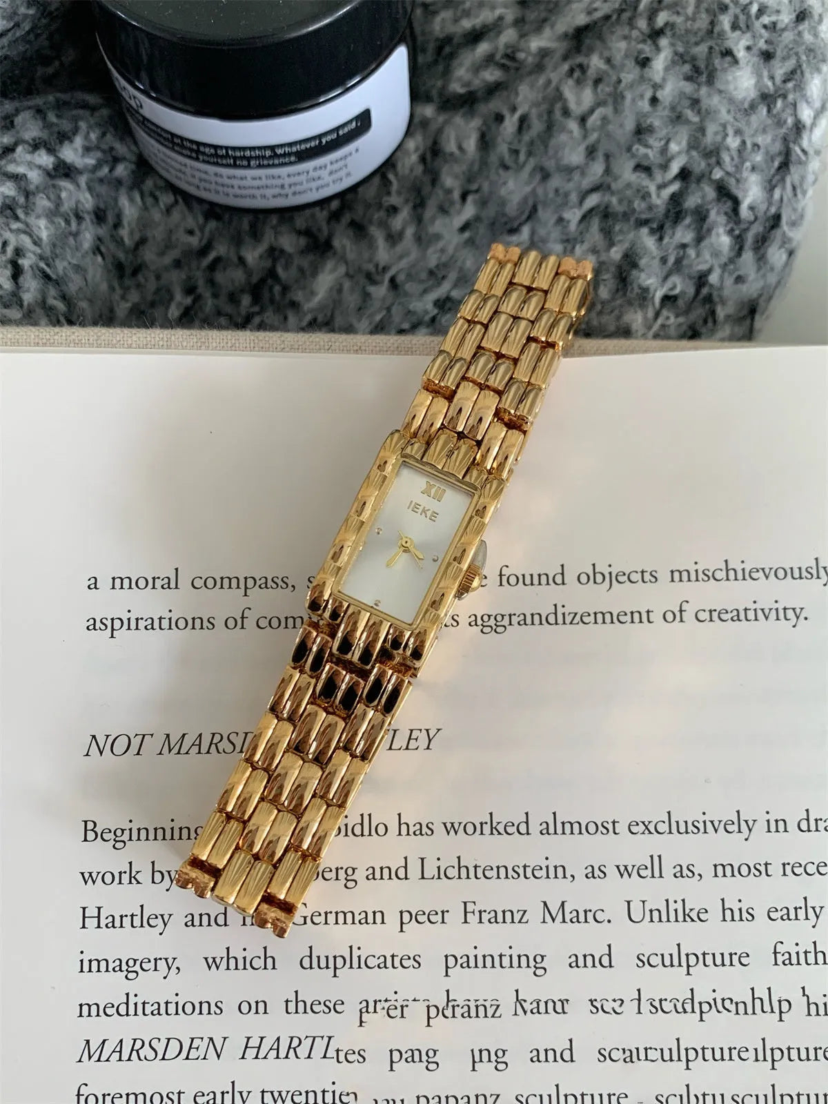 Women's vintage bracelet watch with a small dial, butterfly buckle, on a silver strap.