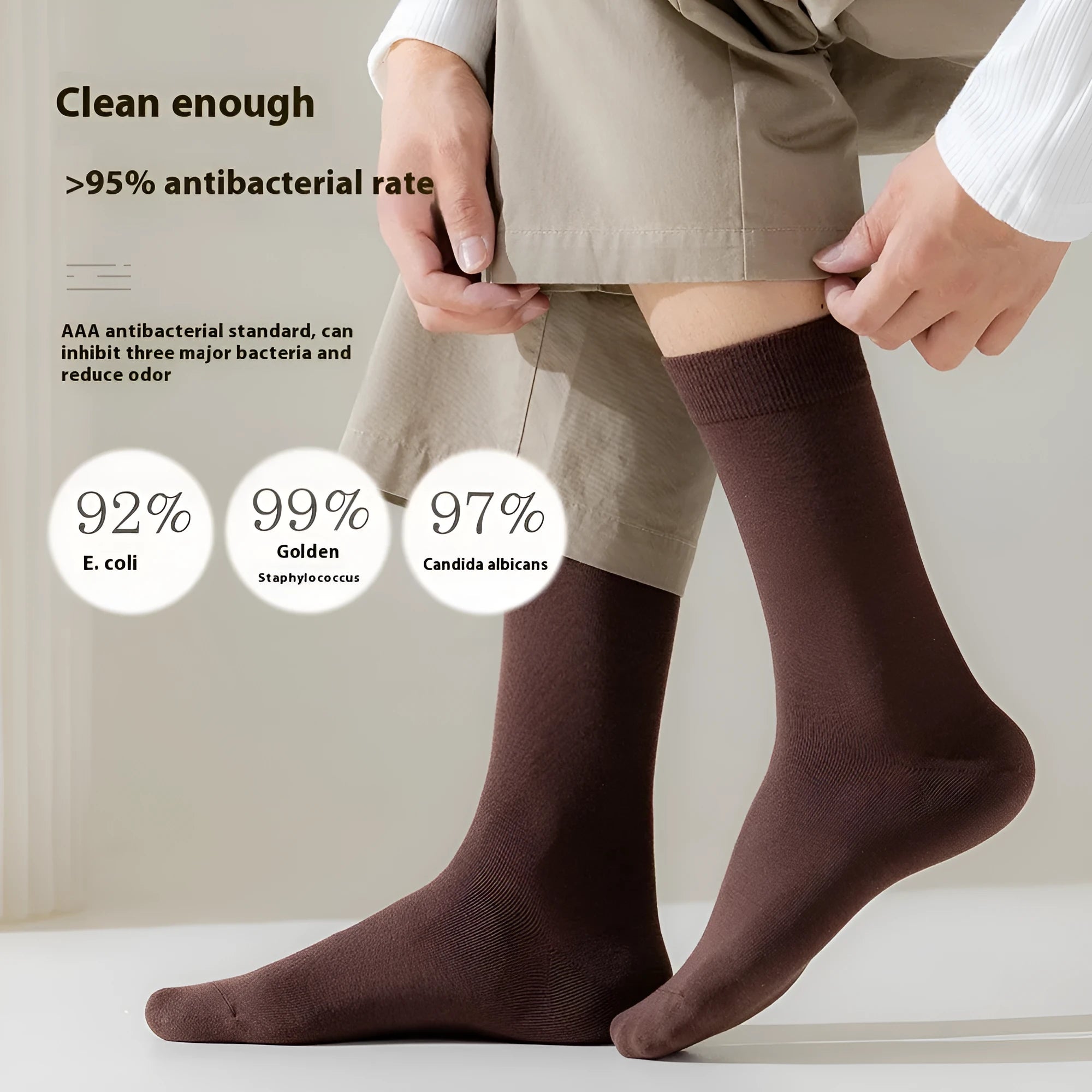 Men's solid colour mid-calf business socks made from combed cotton in various colours on a plain background.