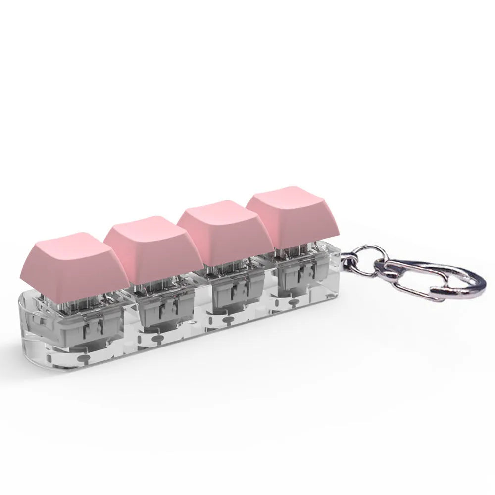 Four-key mechanical keyboard switch tester made of ABS plastic on a desk.
