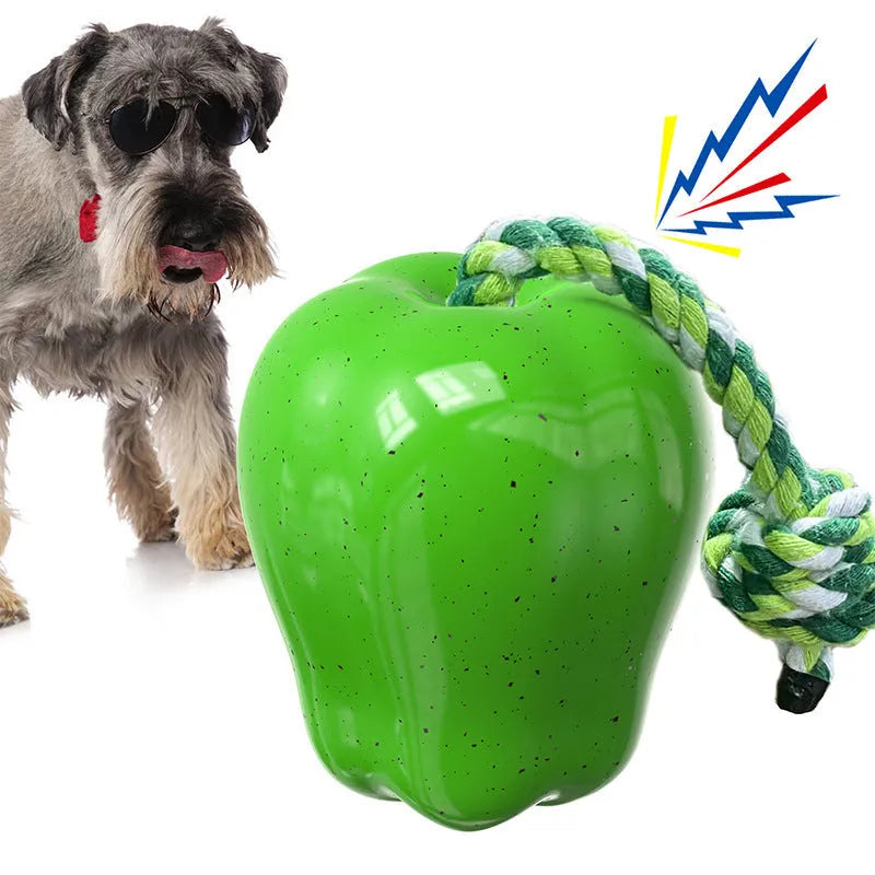 Green plastic dog toy shaped like an apple with a molar texture and a food-dropping ball.