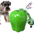 Green plastic dog toy shaped like an apple with a molar texture and a food-dropping ball.