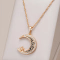 Rose gold-tone moon and star pendant necklace with enamel details on a water wave chain.