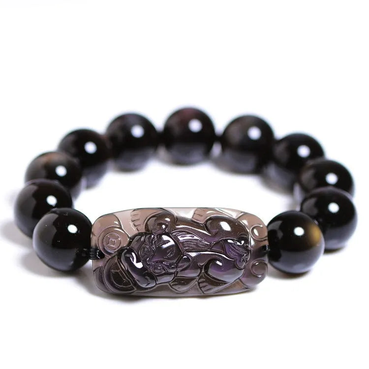 Natural icy obsidian crystal Pi Xiu bracelet with geometric beads on a white background.