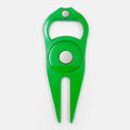 Zinc alloy golf ball yoke and bottle opener tool in black or green on a putting green.