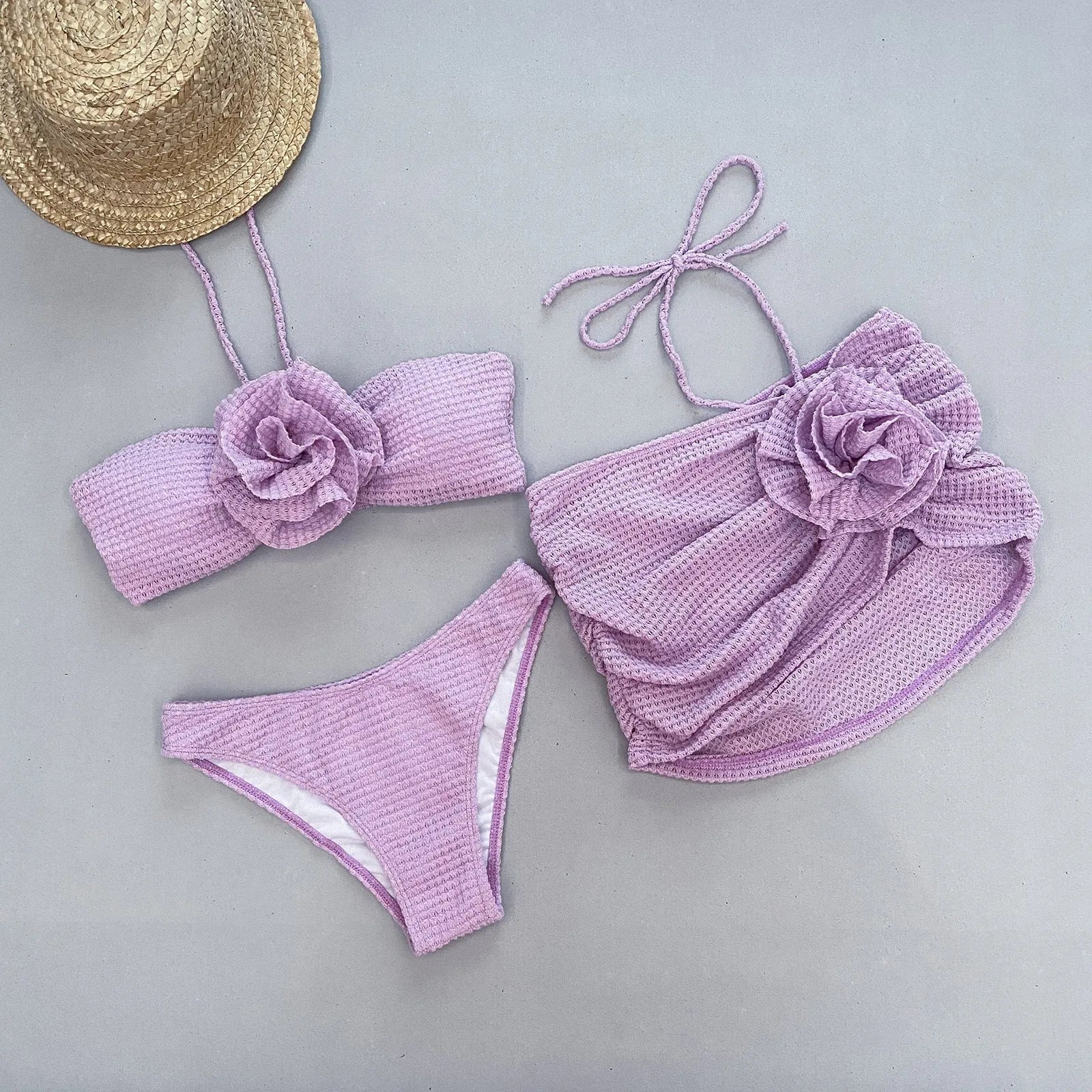 Women's white and purple 3D flower split bikini three-piece swimsuit set on a mannequin