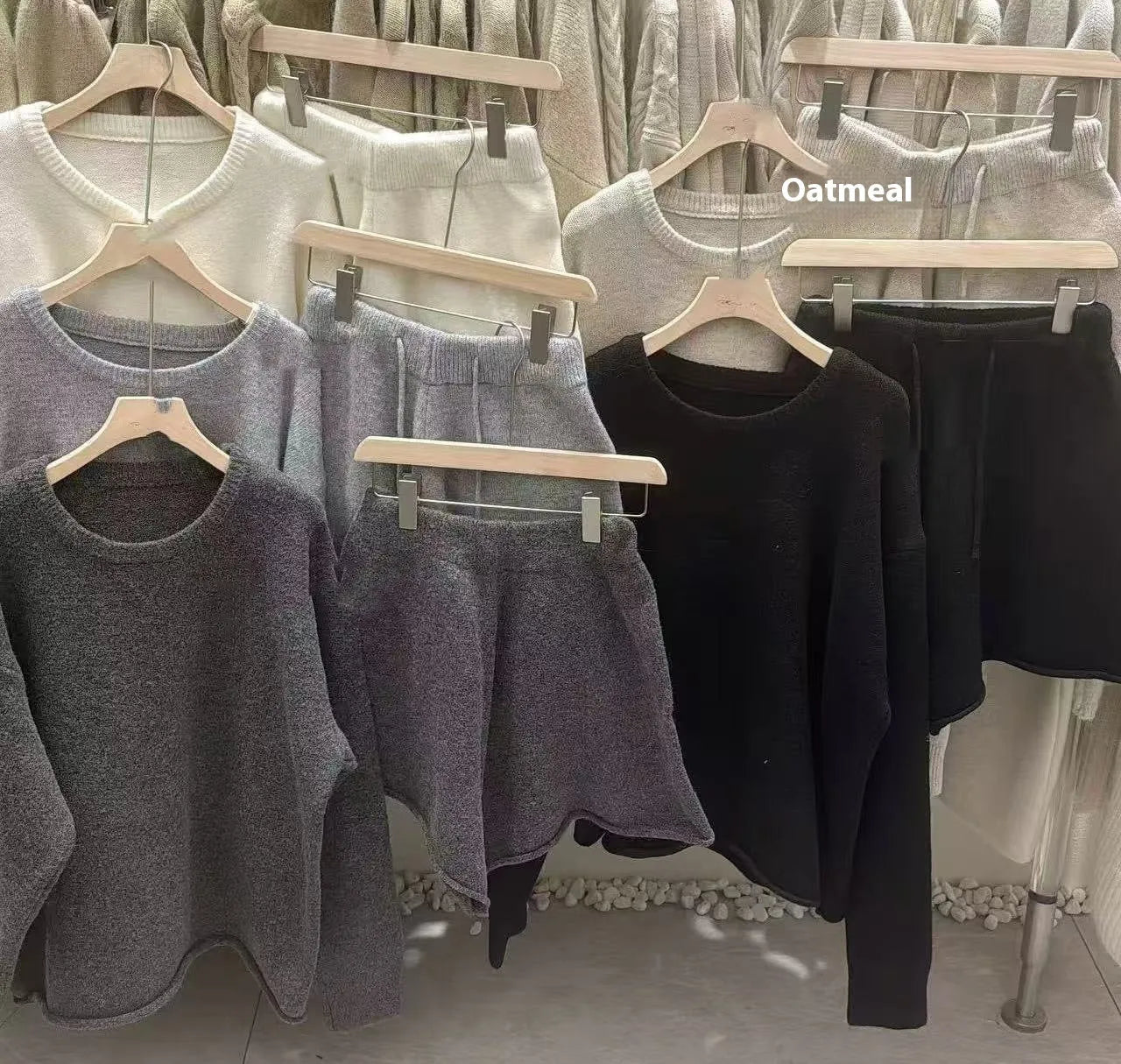 Women's knitted two-piece set showing long sleeve sweater with wide leg shorts in oatmeal colour