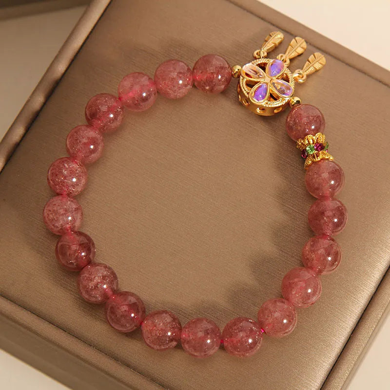 Women's strawberry quartz bracelet with four-leaf dream catcher pendant in natural crystal tones