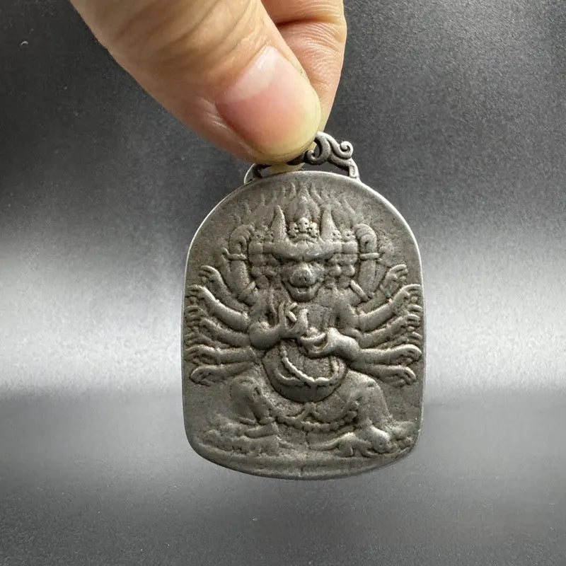 Close-up of a geometric iron pendant ornament in a Chinese style depicting the Aryaacalanatha Yamantaka motif.