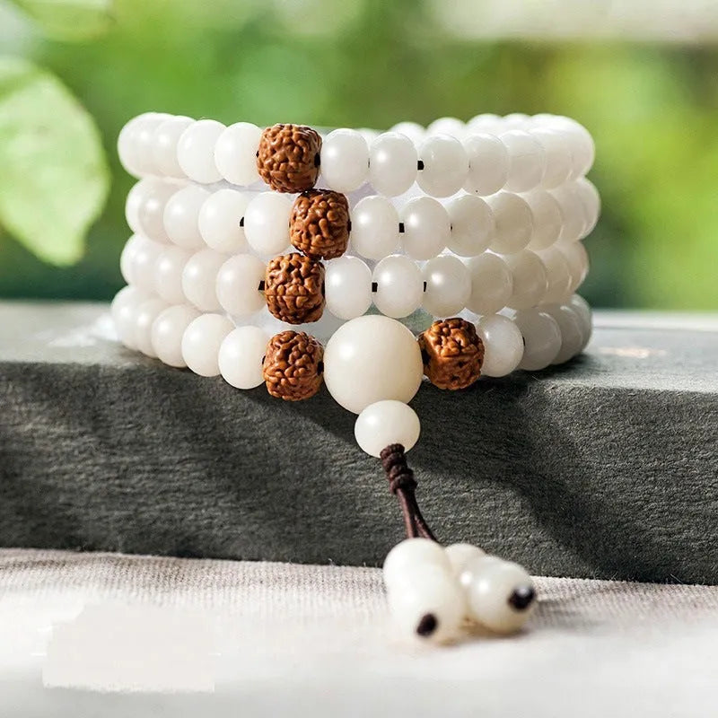 White jade Bodhi seed bracelet with 6x8mm beads showing multiple decorative style options