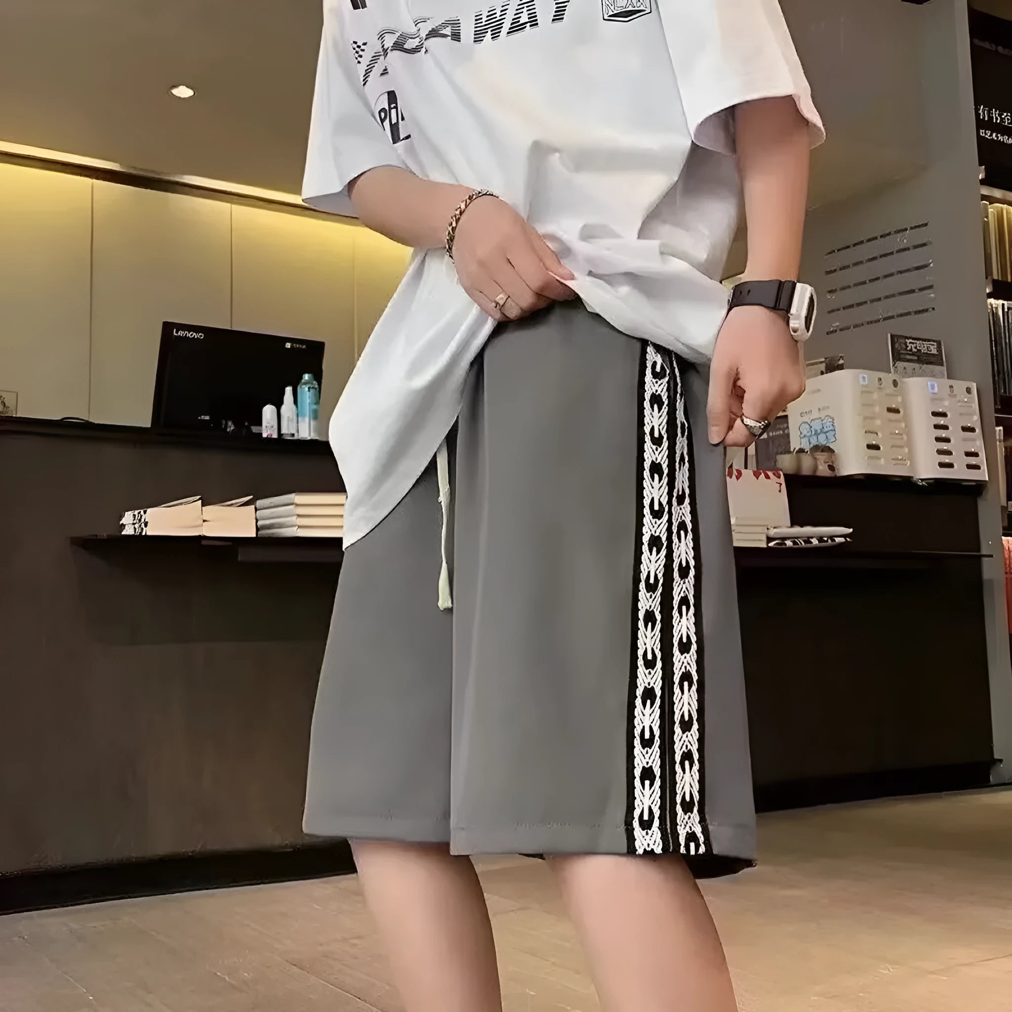 Men's loose-fitting track pants in grey with elastic waistband and baggy leg design