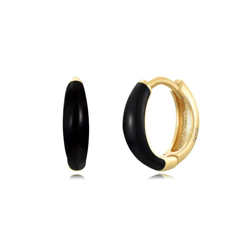 Geometric epoxy resin earrings with dripping oil colour technique showing oval curves and integrated rings