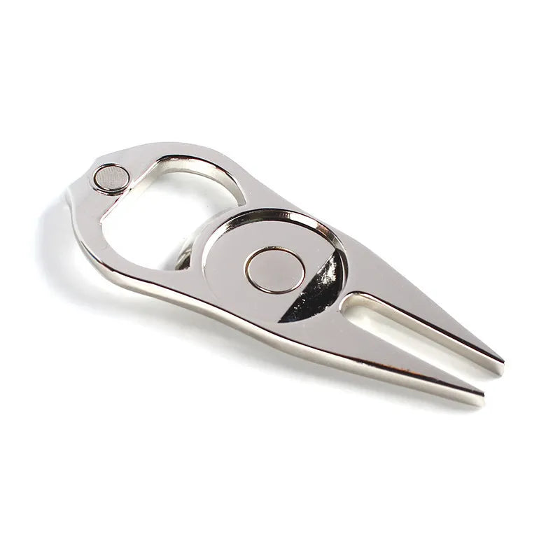Zinc alloy golf ball yoke and bottle opener tool in black or green on a putting green.