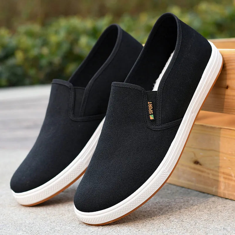 Men's black and blue canvas slip-on shoes with round toe design and composite soles