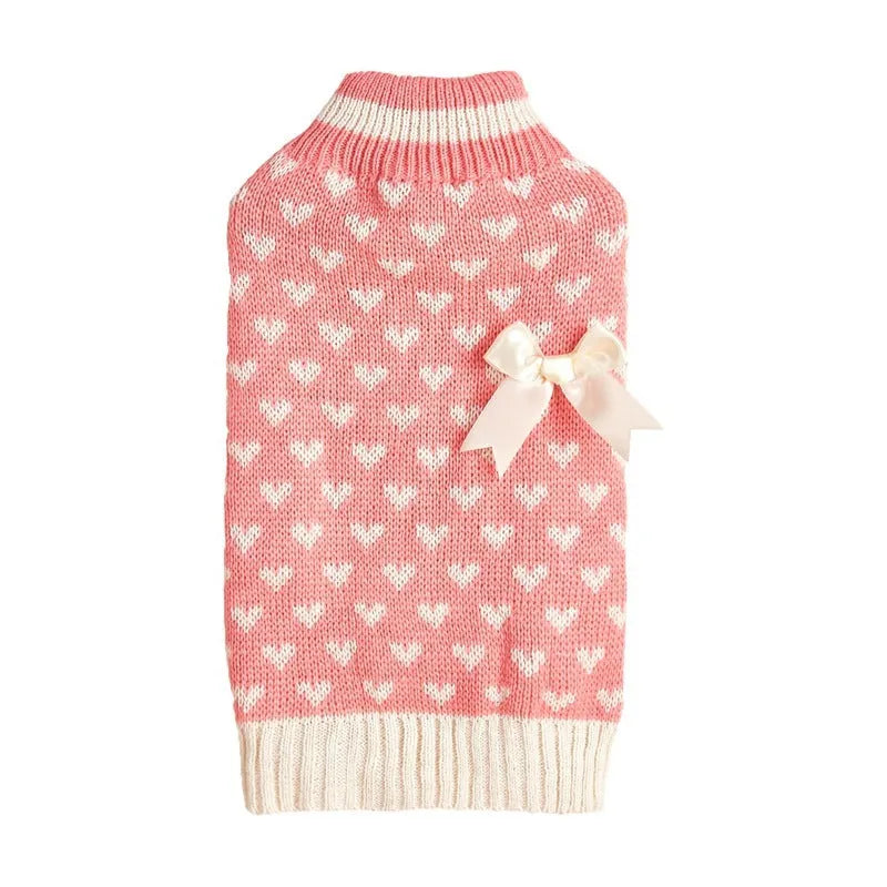 Red and pink dog sweater with love heart and bow design on a small dog.