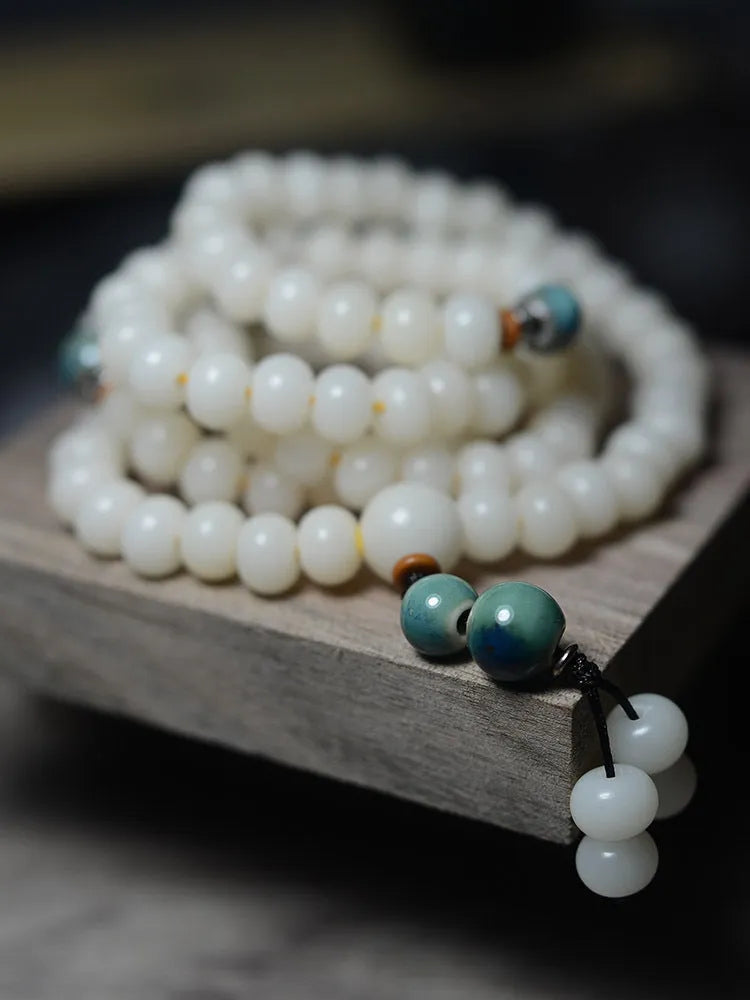 White jade bodhi seed bracelet with 108 flat round beads in 7x9mm and 8x10mm sizes.