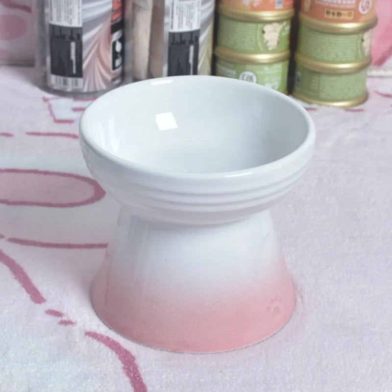 A white ceramic pet bowl with a high foot and raised neck protector to prevent tipping.