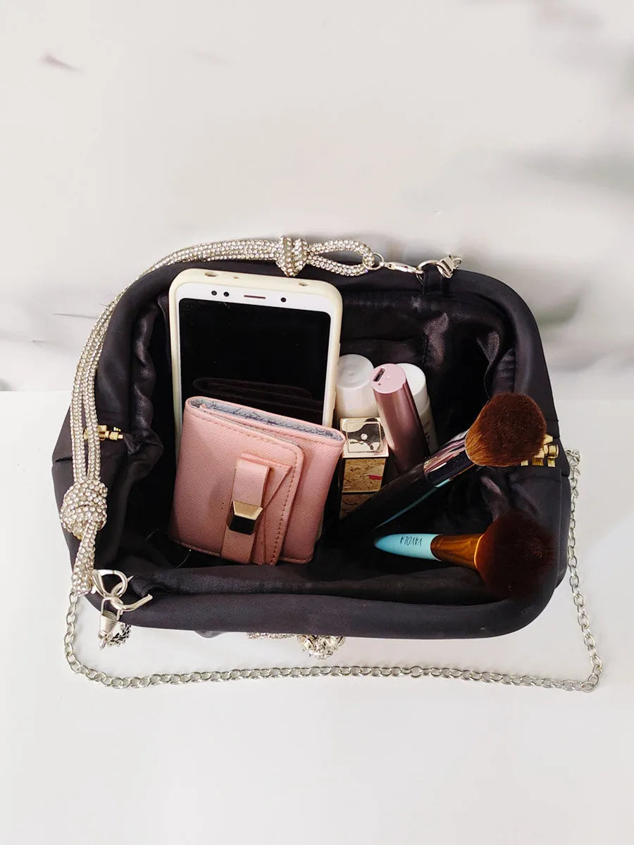 Soft shell-shaped women's large-capacity messenger bag in black, lavender purple, or rose red with fold and chain details.