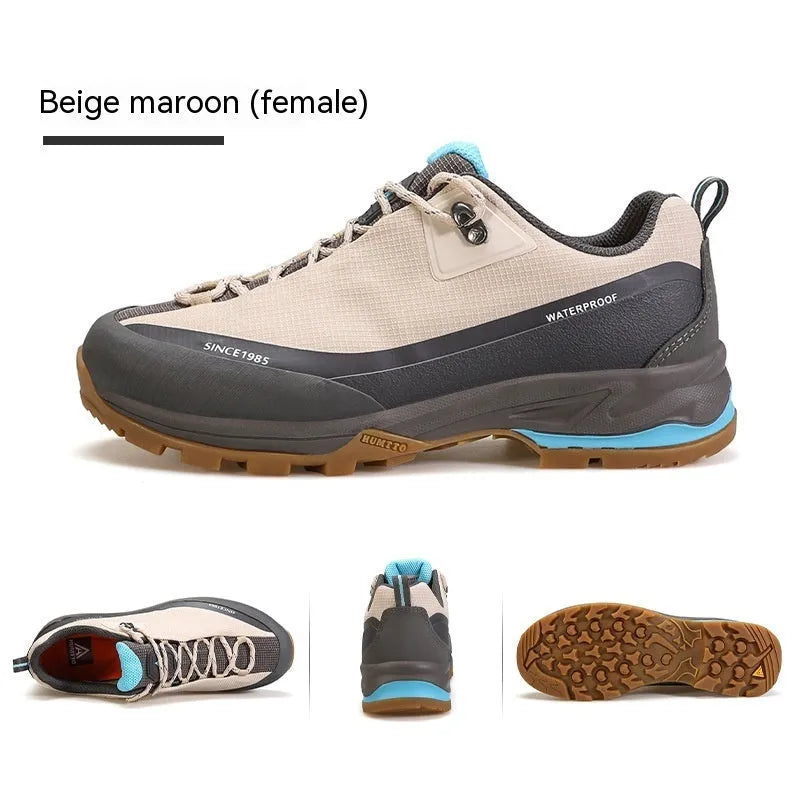 Men's low-top hiking boot in black with front lace-up, rubber outsole, and leather mesh upper.