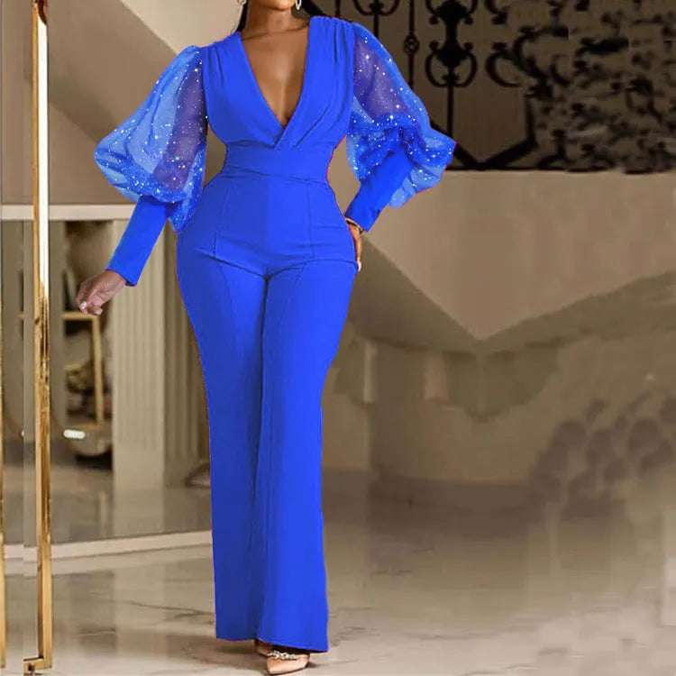 Red long sleeve women's jumpsuit with slim bodice, wide legs, and elasticated waist.