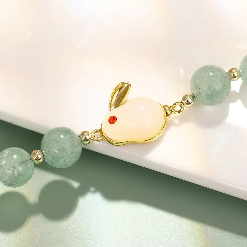 Women's rabbit charm bracelet with natural stone beads and gold accents
