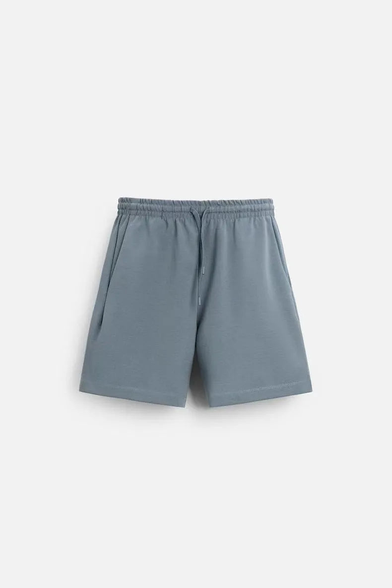 Loose-fitting short sleeve top and matching shorts set in blue, shown on a mannequin.
