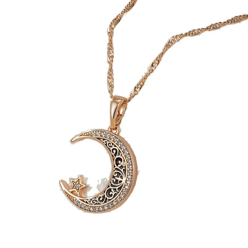 Rose gold-tone moon and star pendant necklace with enamel details on a water wave chain.