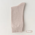 Men's solid colour mid-calf business socks made from combed cotton in various colours on a plain background.