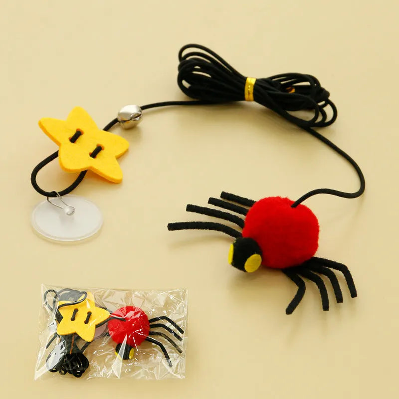 Red and yellow hanging cat toy with elastic rope, feather, bell, and spider elements for door mounting
