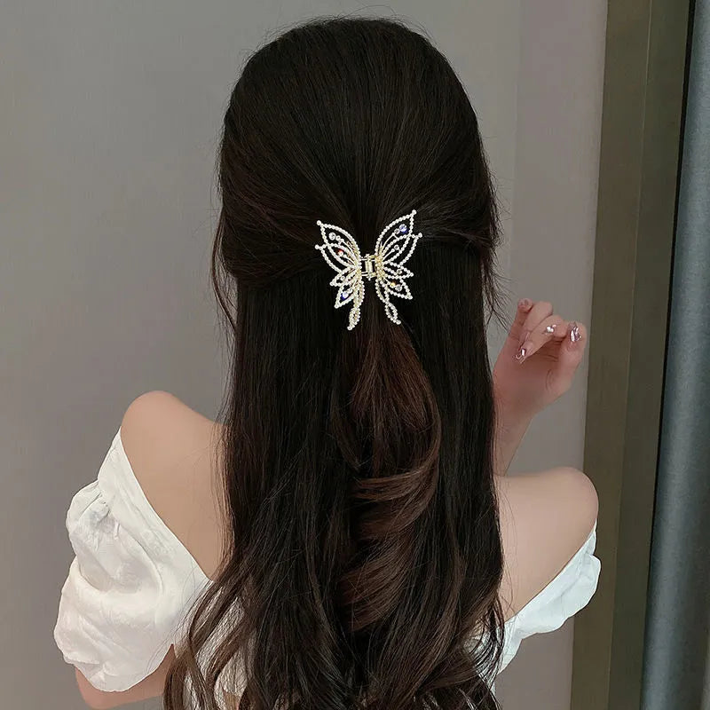 Butterfly-shaped alloy hair clip for women, shown in rhinestone and pearl style options