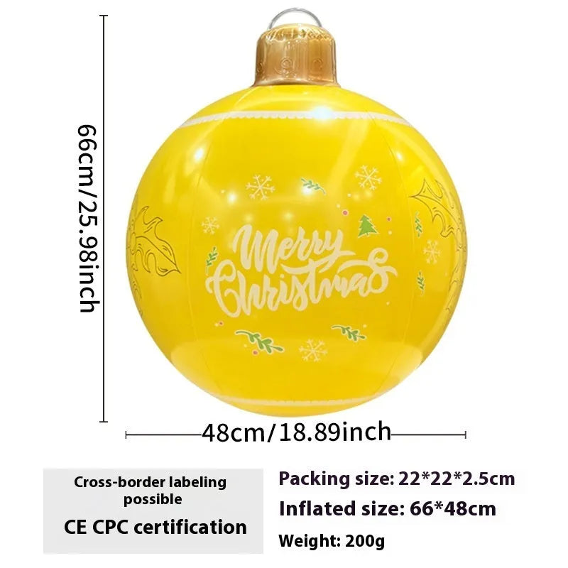 Large red inflatable Christmas ball with snowflake design and LED lights in outdoor garden setting