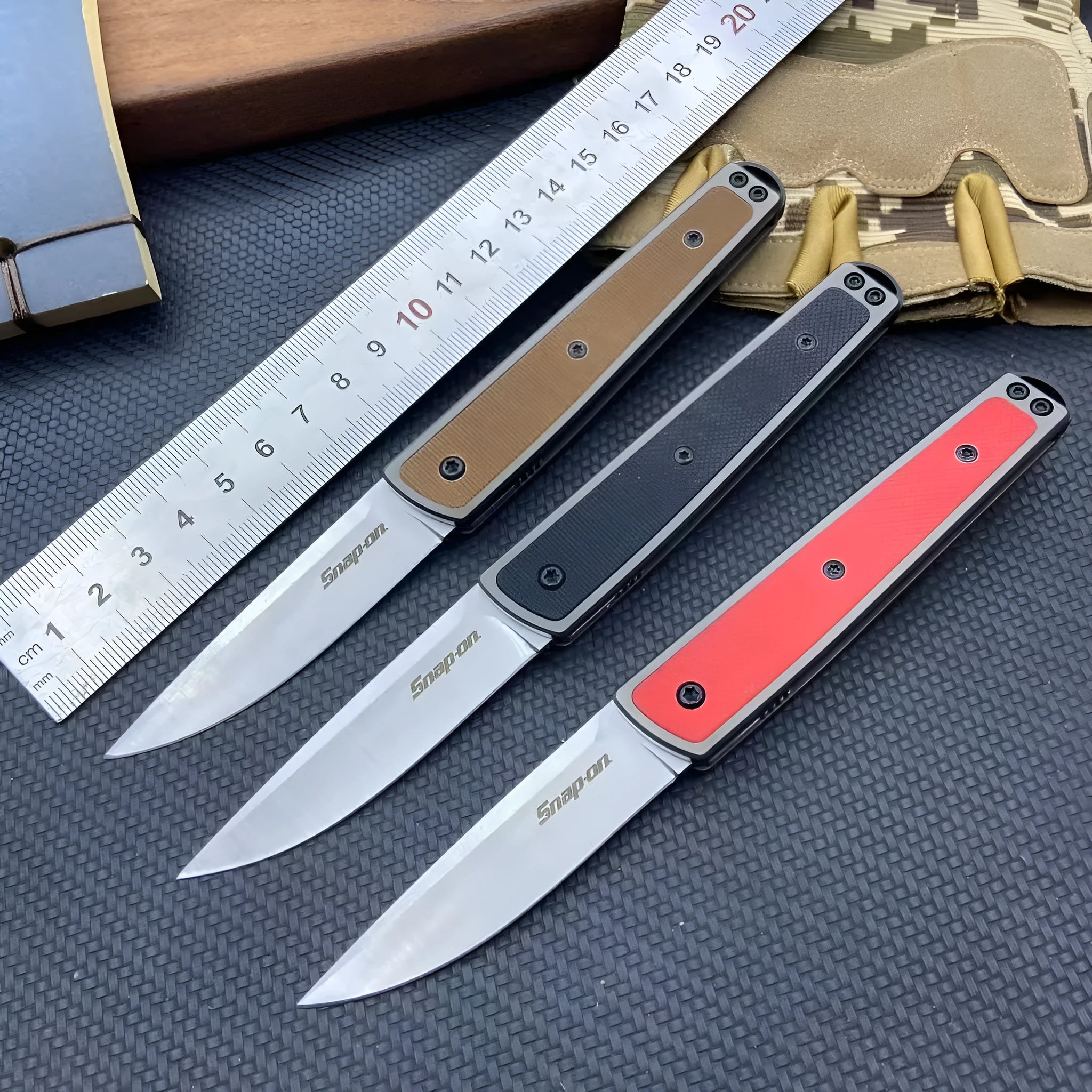 Folding fruit knife with stainless steel blade shown in black, brown, and red colour options