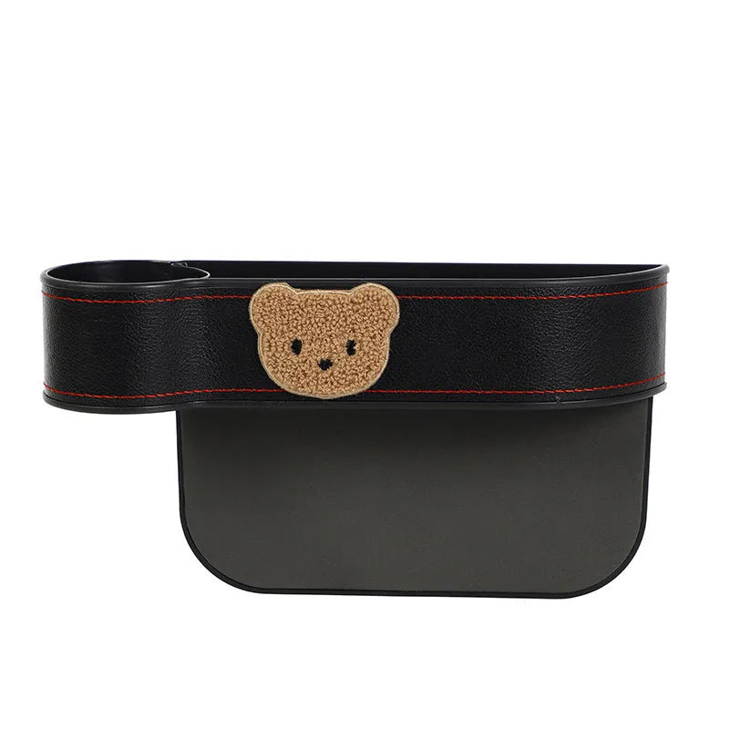 Leather car seat gap storage box with cartoon bear design hanging between vehicle front seats