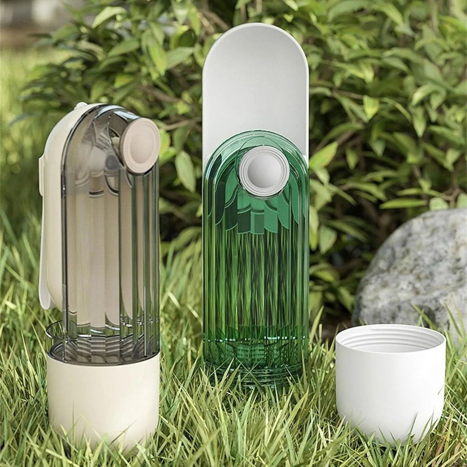 Beige foldable dog water bottle with food container, showing dispenser tray and compact size.