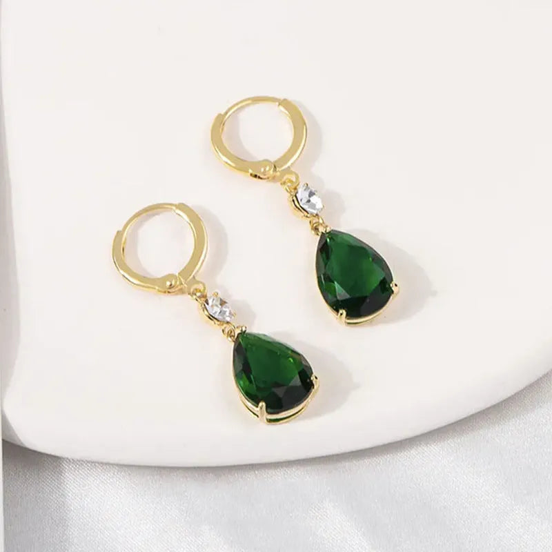 Green geometric teardrop alloy earrings showing structured design from multiple angles