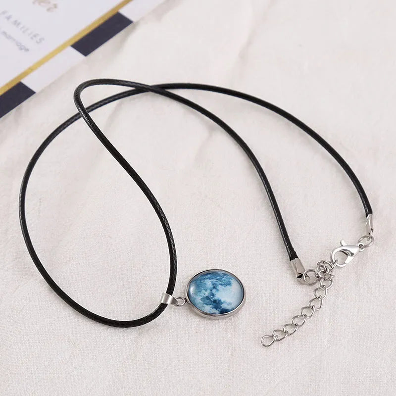 Luminous moon and constellation design pendant on an alloy necklace chain with extension.