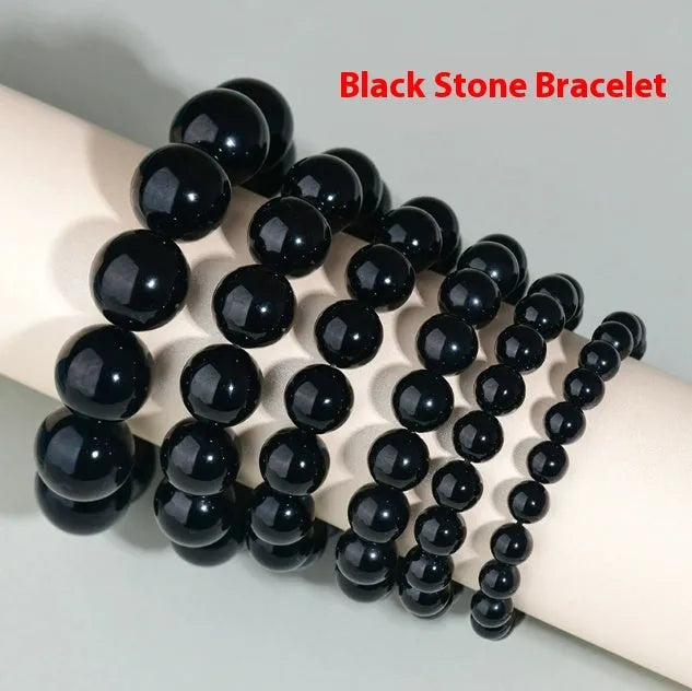 Hand-woven obsidian couple bracelet showing spherical black crystal beads in continuous strand construction
