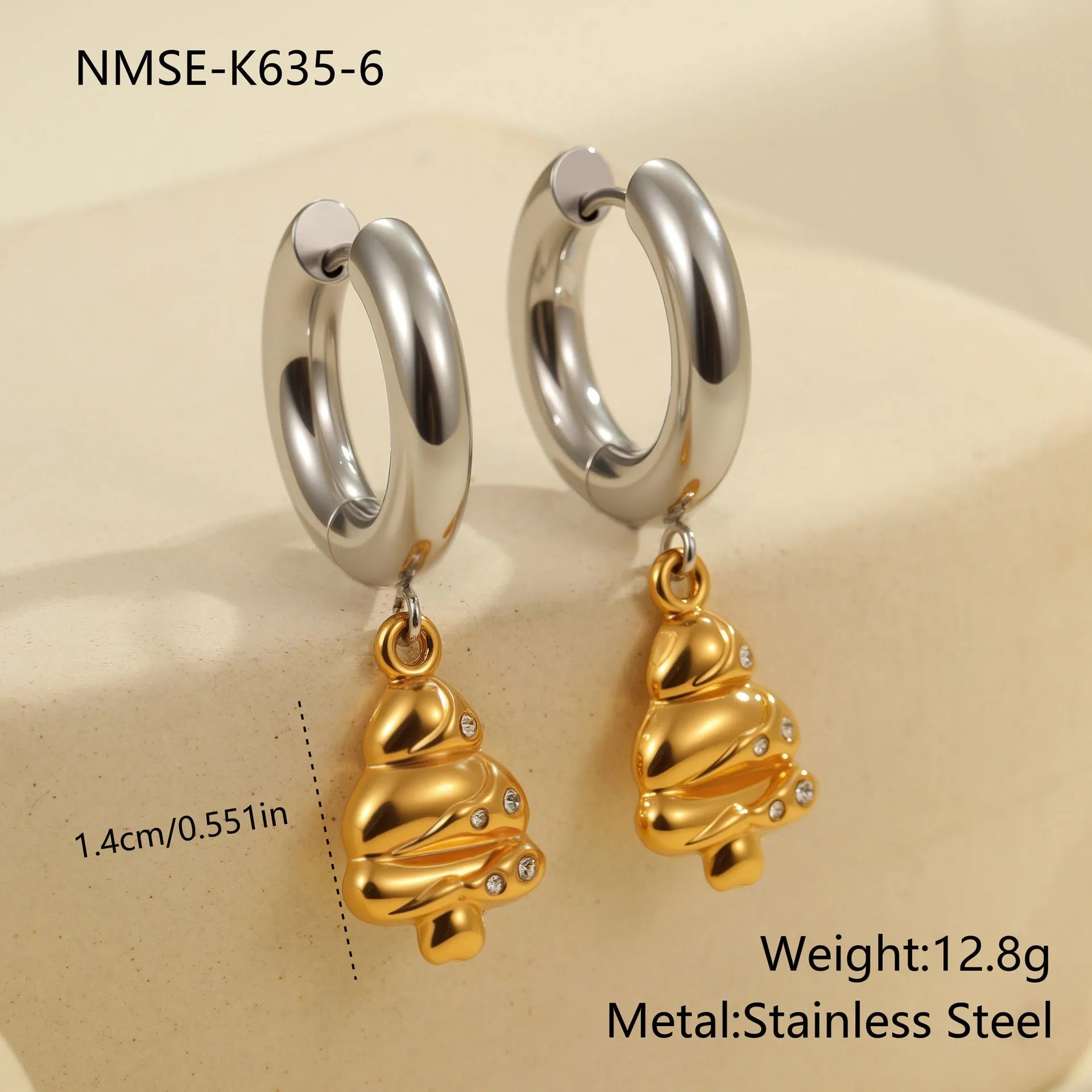 A pair of stainless steel earrings with an 18K gold colour finish, shown in a Christmas tree shape and a heart shape.