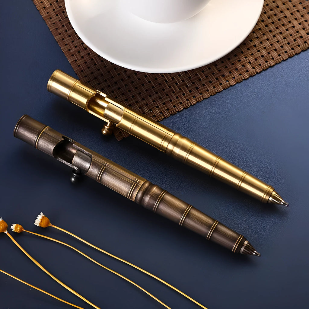 Brass bolt-action tactical pen in a retro copper finish, showing press mechanism and textured barrel.